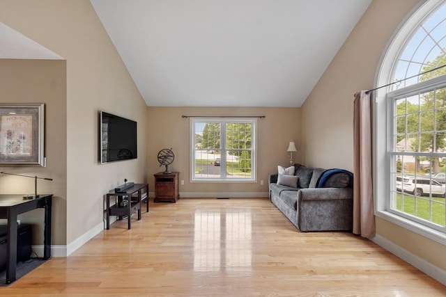 65 Saint Anthony St, Fitchburg, MA 01420 - living area with light wood-style floors, baseboards, and high vaulted ceiling