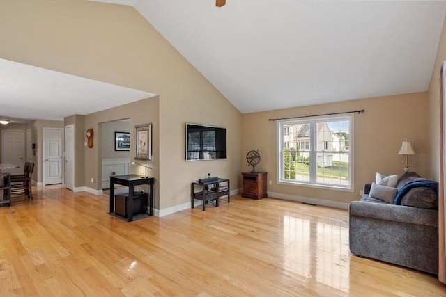 65 Saint Anthony St, Fitchburg, MA 01420 - living room featuring light wood-style flooring, high vaulted ceiling, baseboards, and ceiling fan
