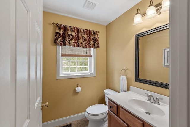 65 Saint Anthony St, Fitchburg, MA 01420 - bathroom with toilet, vanity, baseboards, and tile patterned flooring