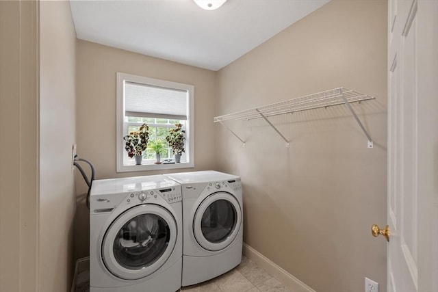 65 Saint Anthony St, Fitchburg, MA 01420 - laundry area featuring washing machine and dryer, baseboards, and light tile patterned floors