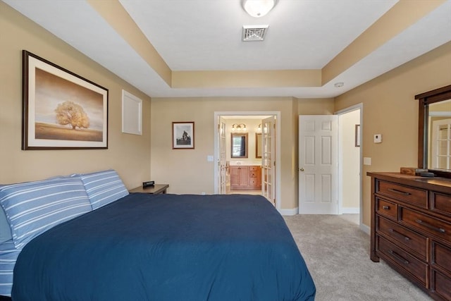 65 Saint Anthony St, Fitchburg, MA 01420 - bedroom featuring light carpet, a raised ceiling, baseboards, and connected bathroom