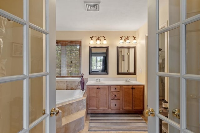 65 Saint Anthony St, Fitchburg, MA 01420 - full bathroom featuring a garden tub and double vanity