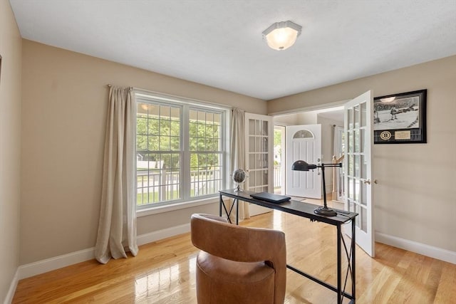 65 Saint Anthony St, Fitchburg, MA 01420 - home office featuring baseboards, light wood-style floors, and french doors