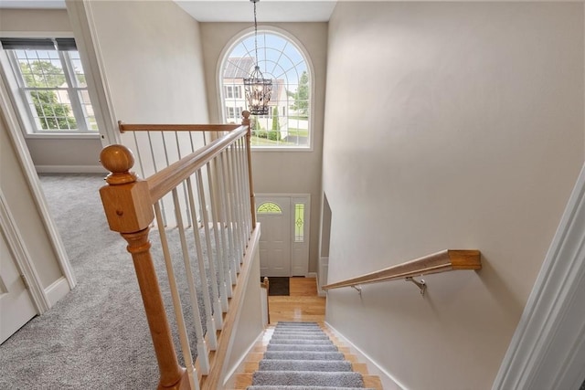 65 Saint Anthony St, Fitchburg, MA 01420 - staircase featuring healthy amount of natural light, a chandelier, and baseboards