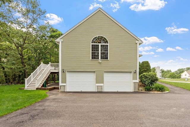 65 Saint Anthony St, Fitchburg, MA 01420 - view of home's exterior with stairs, driveway, a yard, and a garage
