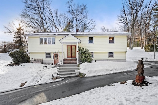 bi-level home featuring a chimney