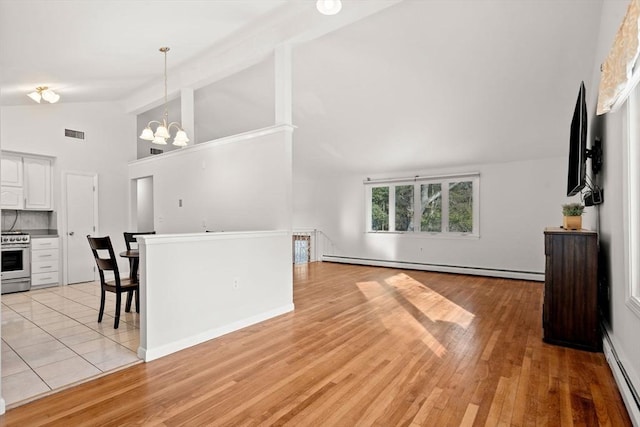 living area with light wood finished floors, a baseboard radiator, visible vents, a baseboard heating unit, and a chandelier