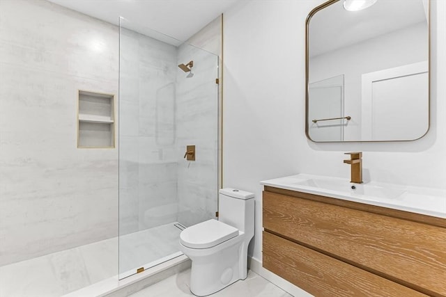 bathroom with toilet, a walk in shower, and vanity