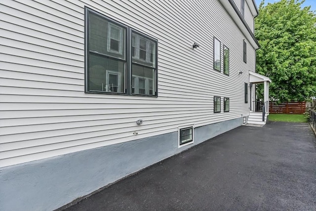 view of side of property with fence and a patio area