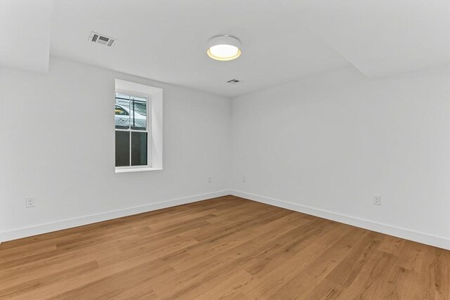 empty room featuring light wood-style flooring and baseboards