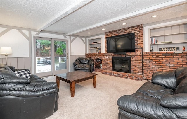 carpeted living room featuring a fireplace, built in features, and a textured ceiling