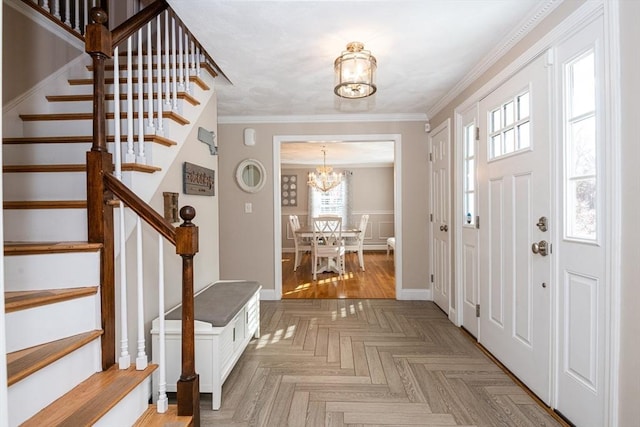 foyer featuring crown molding, parquet floors, and an inviting chandelier