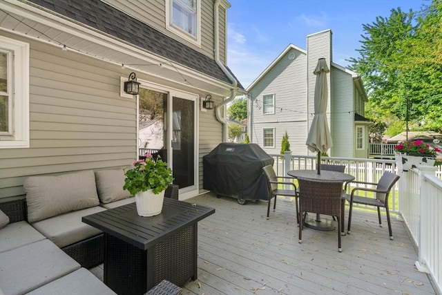 wooden terrace with outdoor lounge area, grilling area, and outdoor dining space