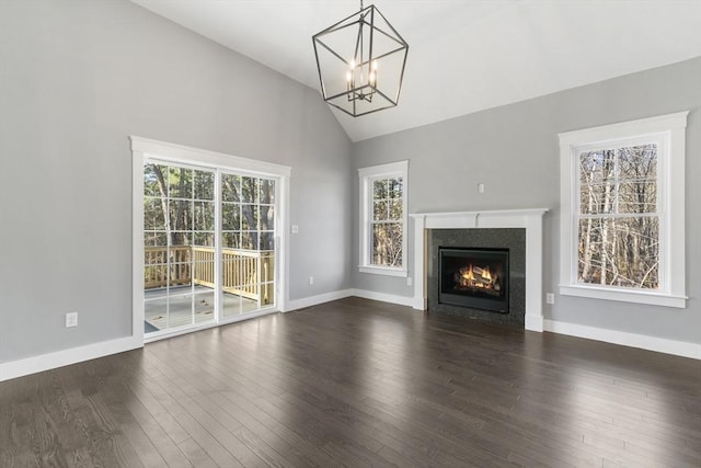 unfurnished living room with lofted ceiling, dark wood-style flooring, and a healthy amount of sunlight