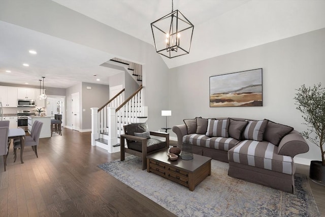 living area featuring a chandelier, recessed lighting, baseboards, stairway, and dark wood-style floors