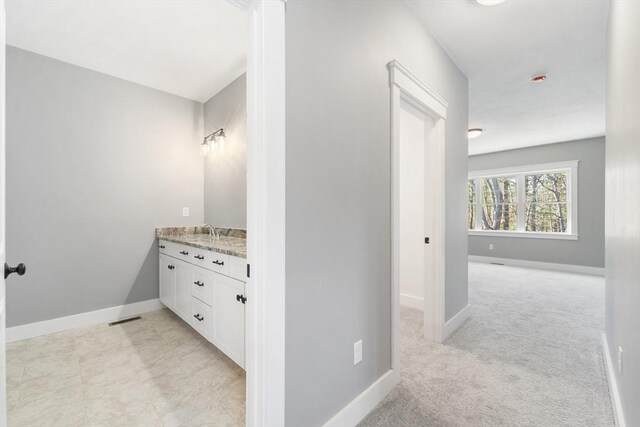 bathroom with baseboards, visible vents, and vanity