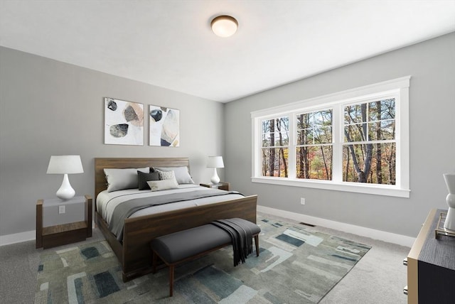 carpeted bedroom featuring baseboards