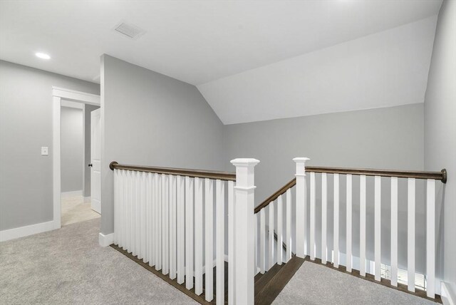 stairway featuring recessed lighting, visible vents, baseboards, vaulted ceiling, and carpet