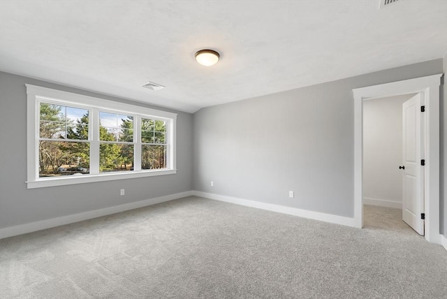 empty room with carpet floors and baseboards