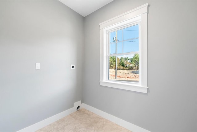 clothes washing area featuring laundry area, baseboards, and electric dryer hookup