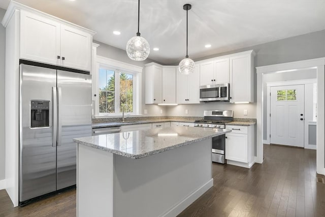 kitchen featuring stainless steel appliances, dark wood finished floors, and white cabinets