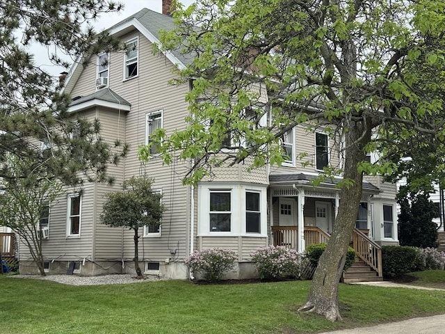 40 Freeman St, Framingham, MA 01702 - view of front of home with a front yard and a chimney