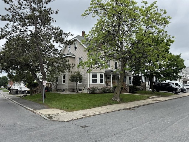 40 Freeman St, Framingham, MA 01702 - view of front of house featuring a chimney and a front lawn