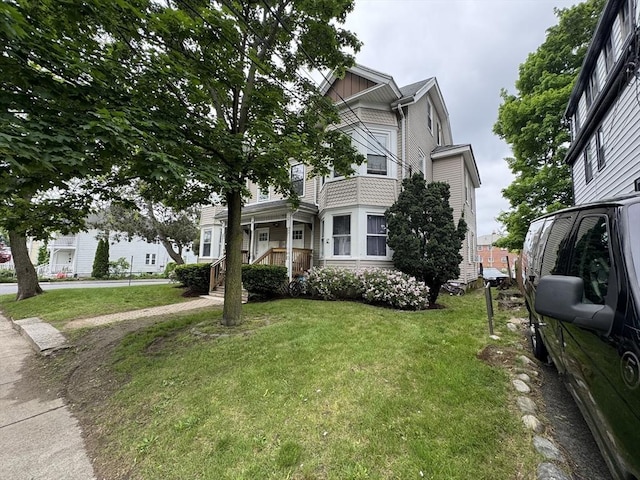 40 Freeman St, Framingham, MA 01702 - view of front of home with a front yard and board and batten siding