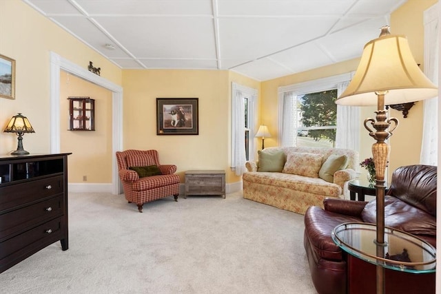 living room featuring baseboards and light colored carpet