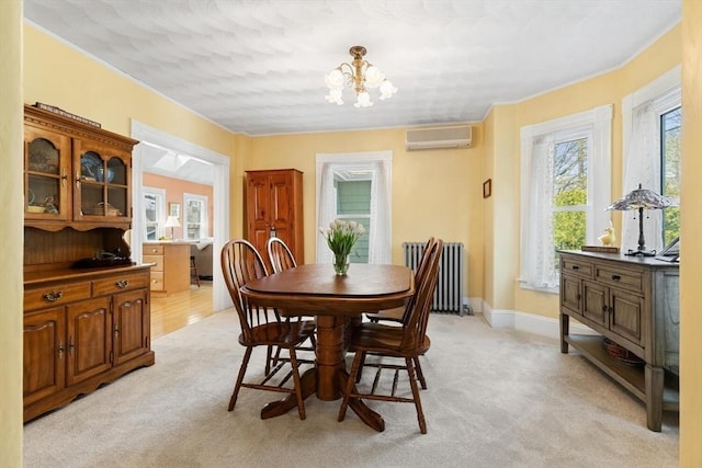 dining area with ornamental molding, radiator, a wall mounted air conditioner, light colored carpet, and a notable chandelier