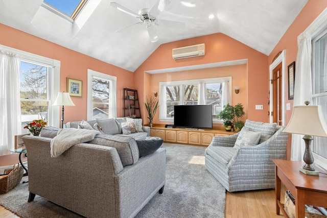 living room with a healthy amount of sunlight, a ceiling fan, lofted ceiling with skylight, and a wall mounted air conditioner