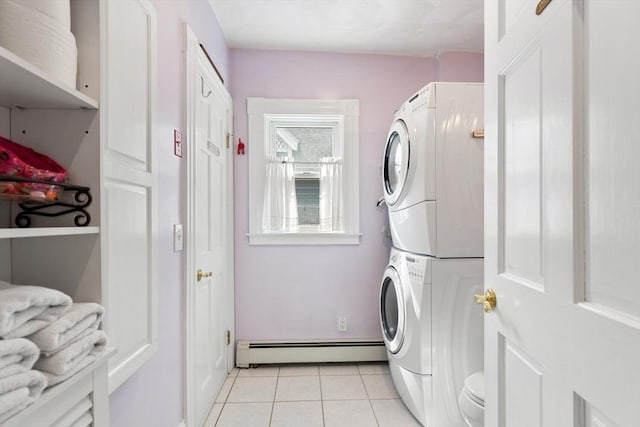 washroom featuring laundry area, stacked washing maching and dryer, a baseboard heating unit, and light tile patterned floors
