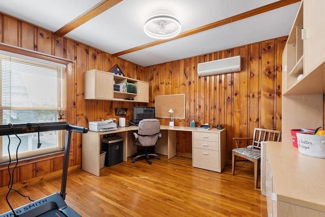 home office with light wood-type flooring, wood walls, built in desk, and a wall mounted AC