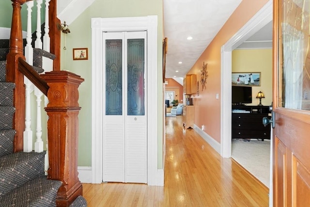 hall featuring recessed lighting, stairs, and wood finished floors