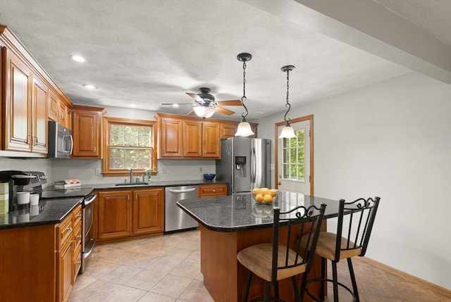 6 2nd Ave, Wilmington, MA 01887 - kitchen featuring appliances with stainless steel finishes, a sink, healthy amount of natural light, a breakfast bar area, and recessed lighting