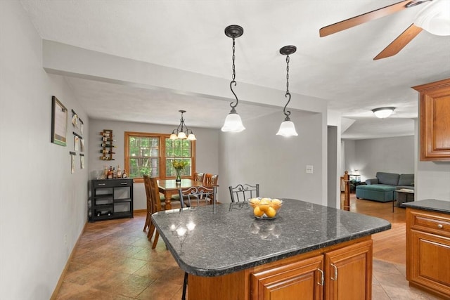 6 2nd Ave, Wilmington, MA 01887 - kitchen with brown cabinetry, a kitchen island, and decorative light fixtures