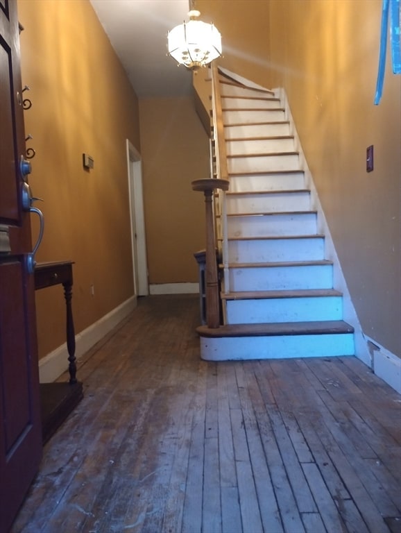 stairway featuring wood-type flooring