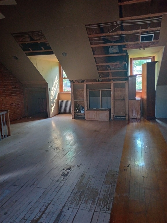 additional living space featuring hardwood / wood-style flooring