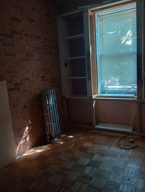 unfurnished room featuring dark parquet floors