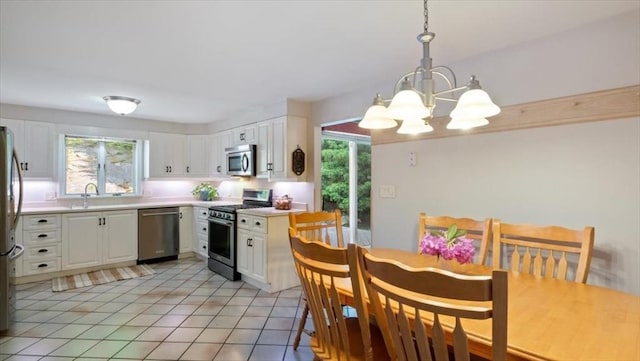 28 Philmart Dr, New Ipswich, NH 03071 - kitchen featuring appliances with stainless steel finishes, a chandelier, plenty of natural light, and white cabinets