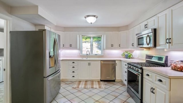 28 Philmart Dr, New Ipswich, NH 03071 - kitchen with stainless steel appliances, light countertops, light tile patterned floors, and white cabinets