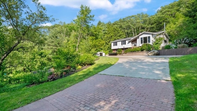 28 Philmart Dr, New Ipswich, NH 03071 - view of front facade featuring driveway, a view of trees, and a front yard
