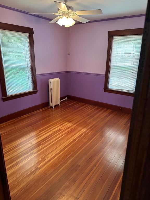 41 Mayland St, Fitchburg, MA 01420 - spare room with radiator, wood finished floors, a ceiling fan, and baseboards