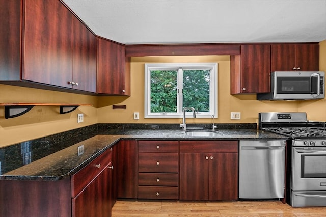 7 Beaver St, Beverly, MA 01915 - kitchen with appliances with stainless steel finishes, a sink, reddish brown cabinets, and dark stone countertops