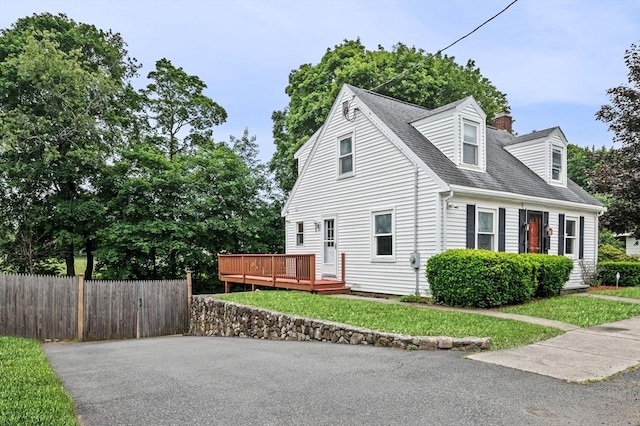 7 Beaver St, Beverly, MA 01915 - view of side of home featuring a deck, a chimney, and roof with shingles