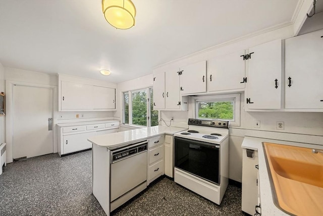 kitchen featuring white appliances, white cabinetry, light countertops, a sink, and a peninsula