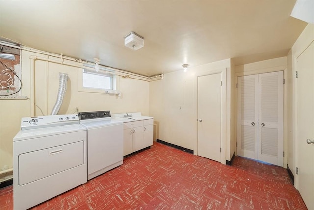 clothes washing area featuring washer and clothes dryer, tile patterned floors, and cabinet space