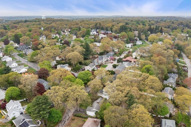 aerial view of property's location with a heavily wooded area and nearby suburban area