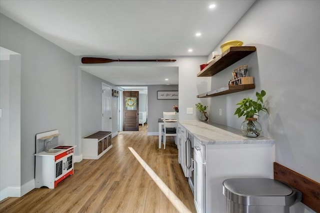 interior space featuring light wood-style floors, baseboards, and recessed lighting