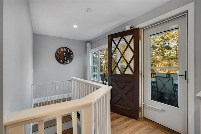 doorway with light wood finished floors and recessed lighting